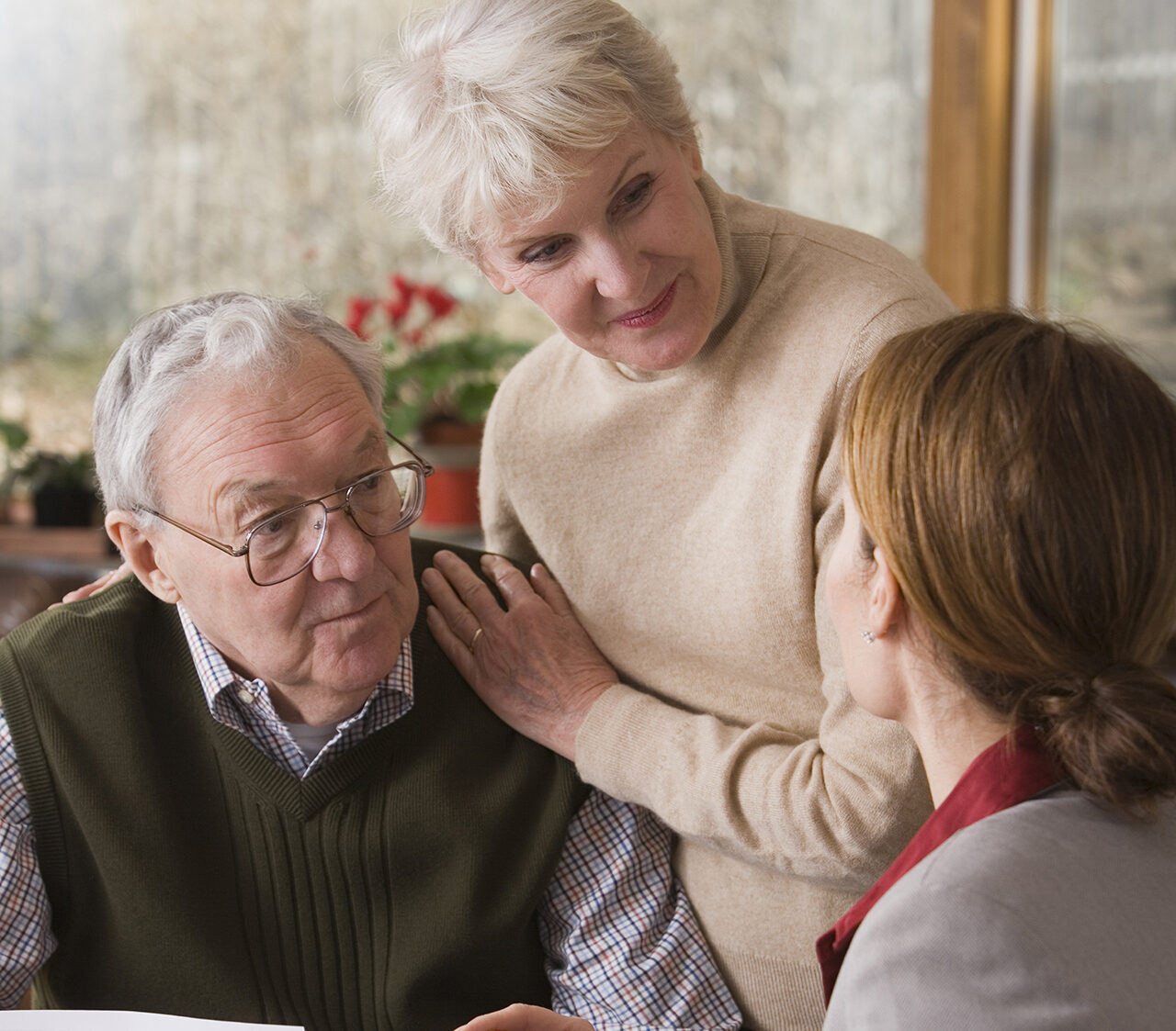 Couple conversing with financial adviser