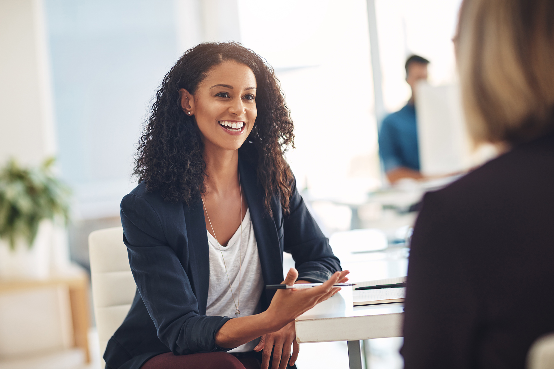Shot of two young women having a conversation in a modern office